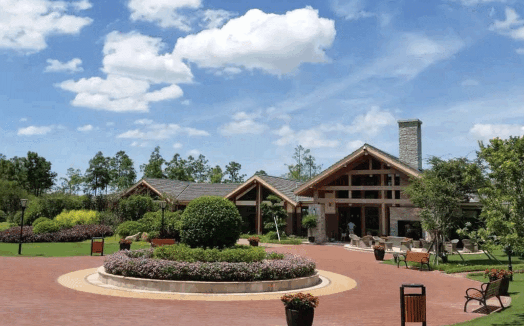Clubhouse with pitched roof and circular driveway entrance.